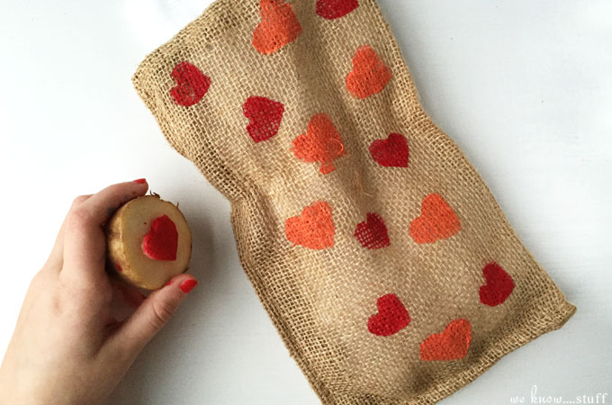 These homemade dog treat bags are the perfect Valentine's Day gift for the dog in your life. This potato stamp project is an easy and fun kid's craft.