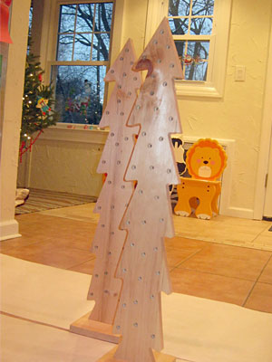 This Christmas Tree craft for kids uses wood trees with pre-drilled holes from Michaels. Once painted, they make great keepsake decorations. This Christmas Tree craft for kids uses wood trees with pre-drilled holes from Michaels. Once painted, they make great keepsake decorations.